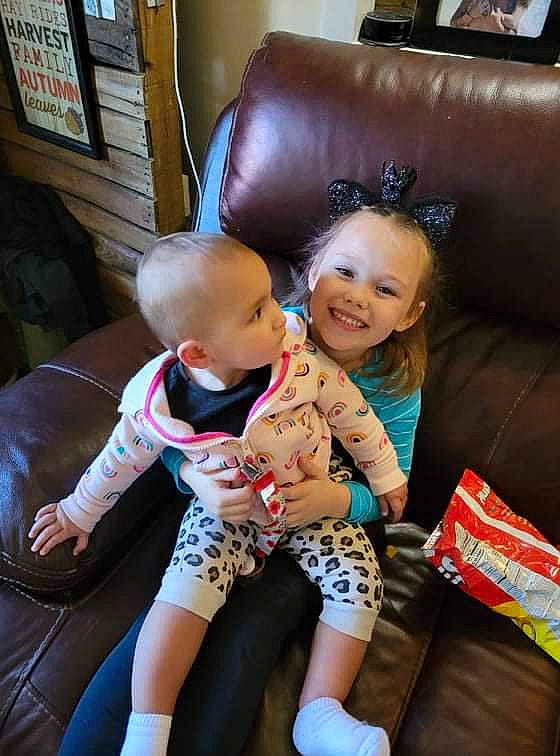 Charlie joined the competition — help win amazing prizes! baby, child, comfort, couch, flooring, fun, happy, human_leg, joy, lap, leisure, living_room, mammal, person, picture_frame, room, skin, smile, t_shirt, television