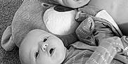 Jaxon joined the competition — help win amazing prizes! baby, infant, pacifier, plush, pillow, carpet, floor, child, clothing, head, face, expression, toy, indoor, person, sleepwear, soft, cute, young, sibling