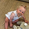 baby, blonde_hair, blue_eyes, bunny, child, curious, cute, flooring, indoor, pacifier, patterned_clothing, person, ponytail, rosy_cheeks, sitting, soft_toy, stuffed_toy, toddler, white_clothing, wooden_floor