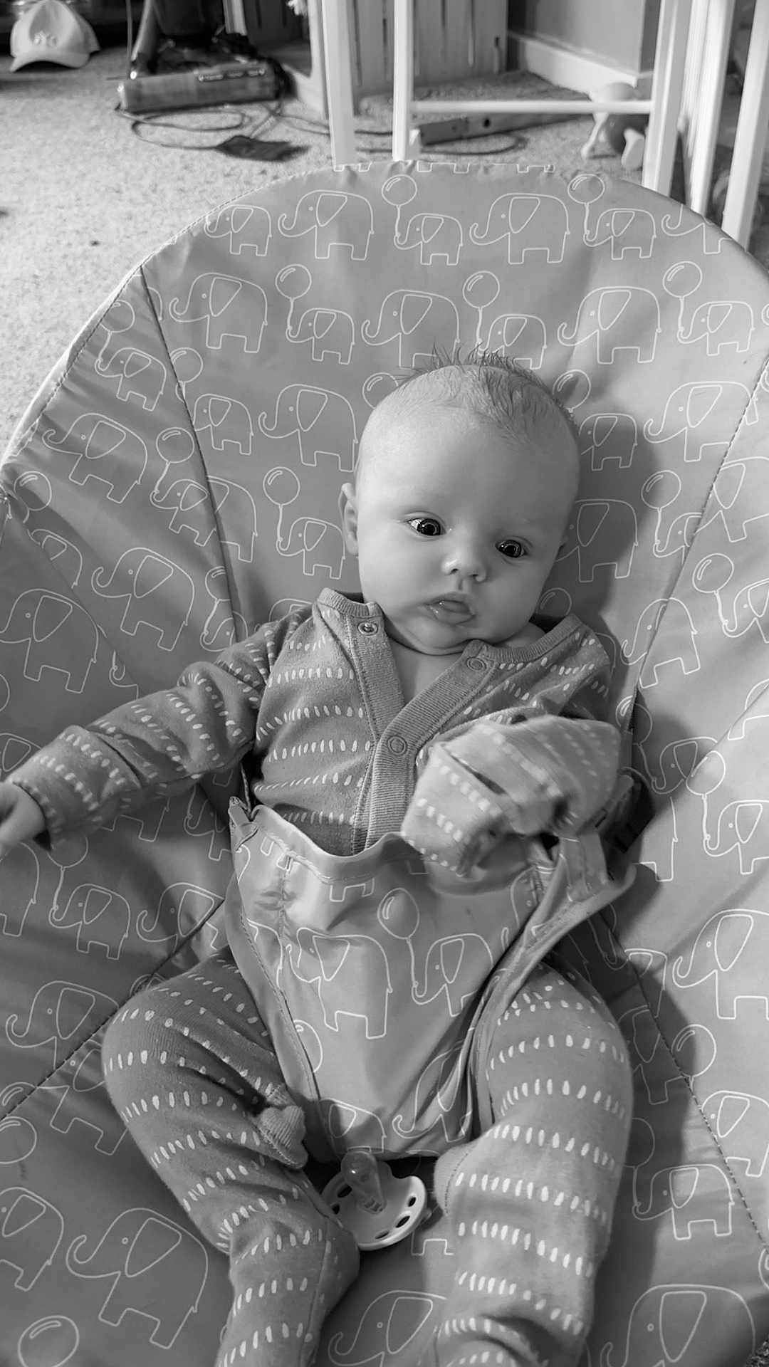 Jaxon joined the competition — help win amazing prizes! baby, infant, pajamas, baby_seat, elephant_pattern, pacifier, carpet, indoors, cushion, child, clothing, face, person, cute, sitting, monochrome, black_and_white, soft_texture, young_child, baby_girl
