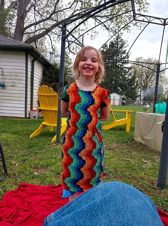 Makenna is registered to the contest to win money with this photo: chair, city, electric_blue, event, fun, garden, grass, happy, joy, lawn, leisure, pattern, person, plant, play, recreation, sitting, sky, smile, toddler