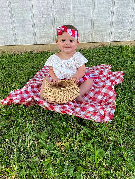 Salem is registered to the contest to win money with this photo: baby_toddler_clothing, basket, cap, child, child_art, costume, costume_hat, event, fashion_accessory, grass, hat, headgear, headwear, joy, pattern, person, picnic_basket, play, recreation, sitting