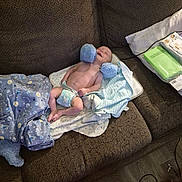 Theodore joined the competition — help win amazing prizes! baby, newborn, infant, couch, blanket, diaper, mittens, baby_wipes, smile, indoor, brown_furniture, soft_toys, cozy, wooden_floor, person, happy, resting, child, comfort, toddler
