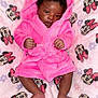 baby, infant, pink_robe, blanket, minnie_mouse, pattern, child, cute, sleepwear, soft_texture, feet, hands, portrait, lying_down, indoor, adorable, face, expression, hood, resting