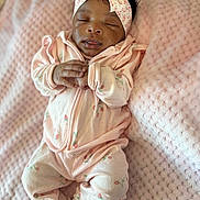 Soular is registered to the contest to win money with this photo: baby, sleeping, pink_outfit, headband, strawberry_pattern, blanket, soft_texture, infant, cute, peaceful, hands_clasped, cozy, newborn, portrait, indoors, child, clothing, headwear, resting, toddler