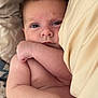 baby, infant, skin, arm, face, blanket, bed, lying_down, close_up, expression, newborn, resting, sleepwear, indoors, cute, child, person, soft, natural_light, comfort