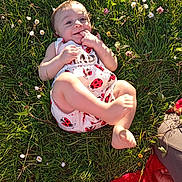 Elena a rejoint le concours — aidez-le/la à gagner de superbes lots ! baby, child, grass, flowers, outdoor, sunlight, happy, smiling, cute, infant, nature, greenery, ladybug_pattern, skin, barefoot, relaxing, summer, playful, person, meadow