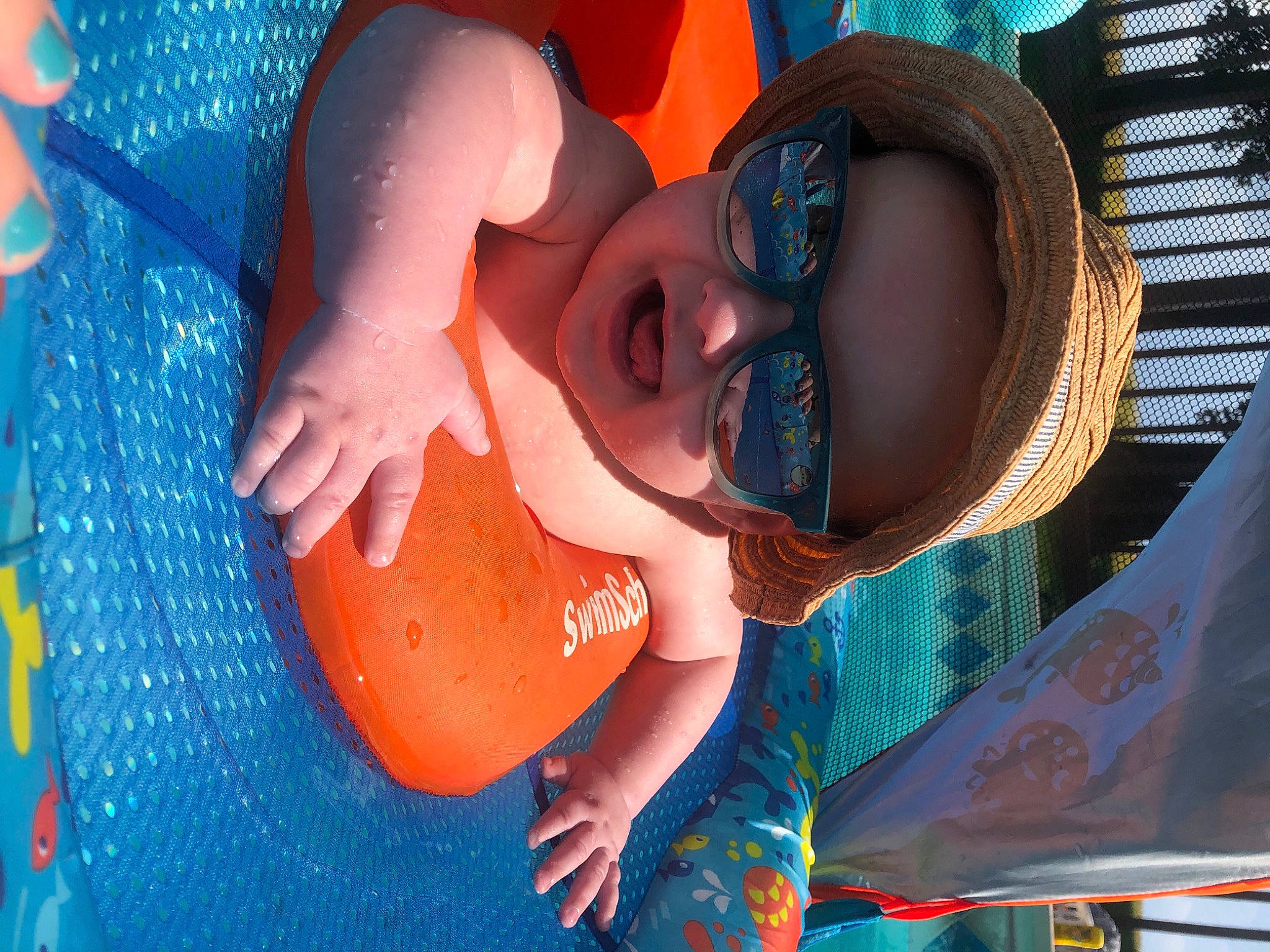 Damion is registered to the contest to win money with this photo: azure, bathing, blue, child, cool, electric_blue, fun, happy, hat, headwear, leisure, mouth, orange, person, personal_protective_equipment, recreation, smile, summer, sun_hat, sunglasses