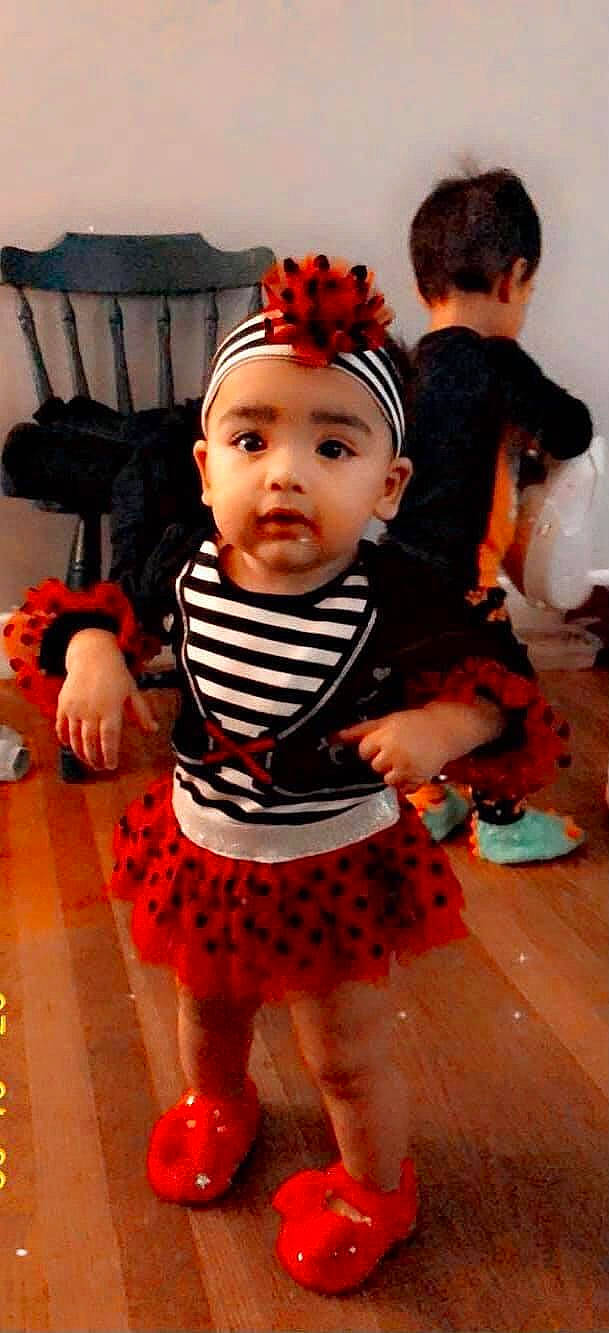 Maylani is registered to the contest to win money with this photo: baby, baby_products, baby_toddler_clothing, cheek, child, costume, costume_accessory, flooring, hair_accessory, headband, headgear, headpiece, headwear, person, play, red, sock, toddler