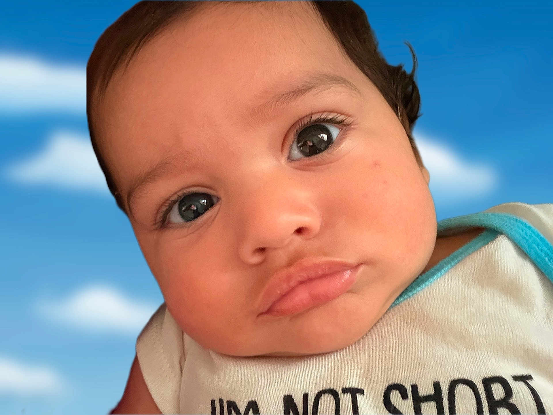 Psalm Graceson is registered to the contest to win money with this photo: baby, closeup, face, eyes, pout, expression, infant, child, skin, clothing, shirt, blue_sky, clouds, portrait, cute, young, person, head, humor, slogan
