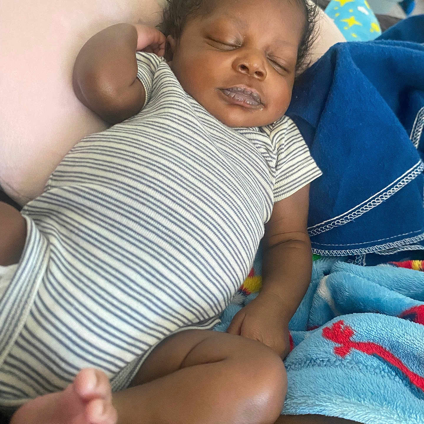 Rayquan joined the competition — help win amazing prizes! baby, blanket, child, cozy, cute, duck_design, foot, hand, indoors, infant, nap, onesie, peaceful, pillow, relaxing, resting, skin, sleeping, soft, striped_clothing