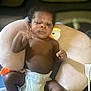 Rayquan is registered to the contest to win money with this photo: baby, infant, diaper, pillow, duck, soft_toy, child, indoor, person, skin, face, expression, cute, newborn, lying_down, plush, comfort, young_child, resting, portrait