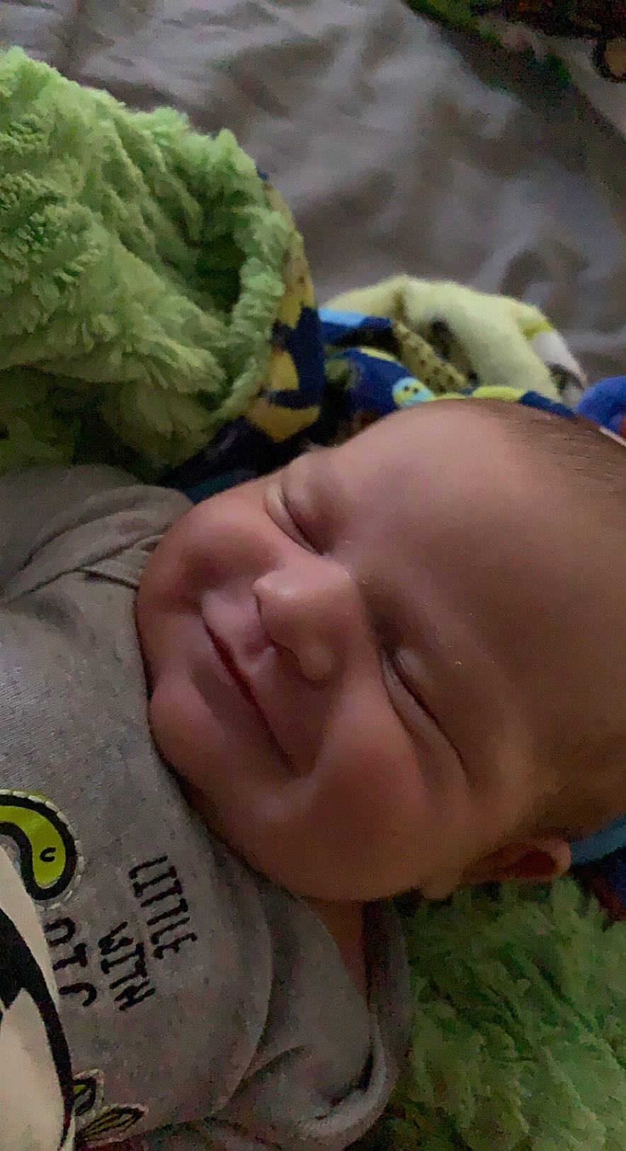 Kylan is registered to the contest to win money with this photo: baby, baby_products, baby_toddler_clothing, cheek, child, comfort, eyelash, forehead, grass, green, happy, head, joy, leaf_vegetable, linens, muscle, nose, person, skin, textile