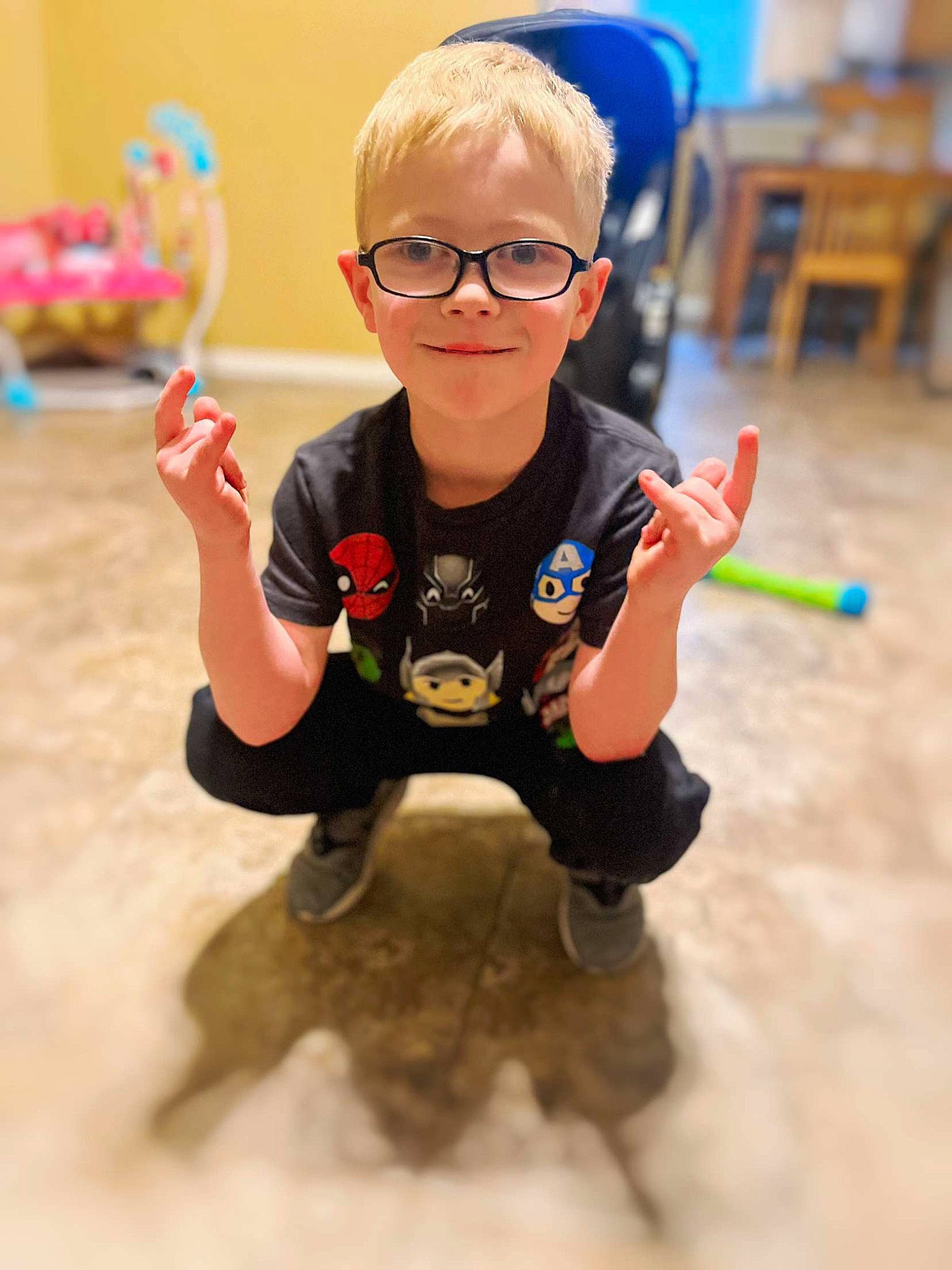 Rayge is registered to the contest to win money with this photo: baby, chair, child, eyewear, finger, flooring, fun, glasses, goggles, happy, joy, leisure, person, shorts, sitting, smile, t_shirt, thumb, toddler, toy