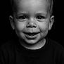 Noah participe au concours pour gagner de l'argent avec cette photo : child, toddler, portrait, black_and_white, smiling, face, water_droplets, happy, close_up, head, person, dark_background, short_hair, sweater, cute, innocence, studio_lighting, expression, young, wet