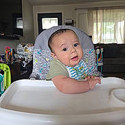 Carlos A Murillo joined the competition — help win amazing prizes! baby, bib, child, curious, cute, expression, face, feeding, food, furniture, high_chair, home, indoor, infant, living_room, person, portrait, seat, table, young