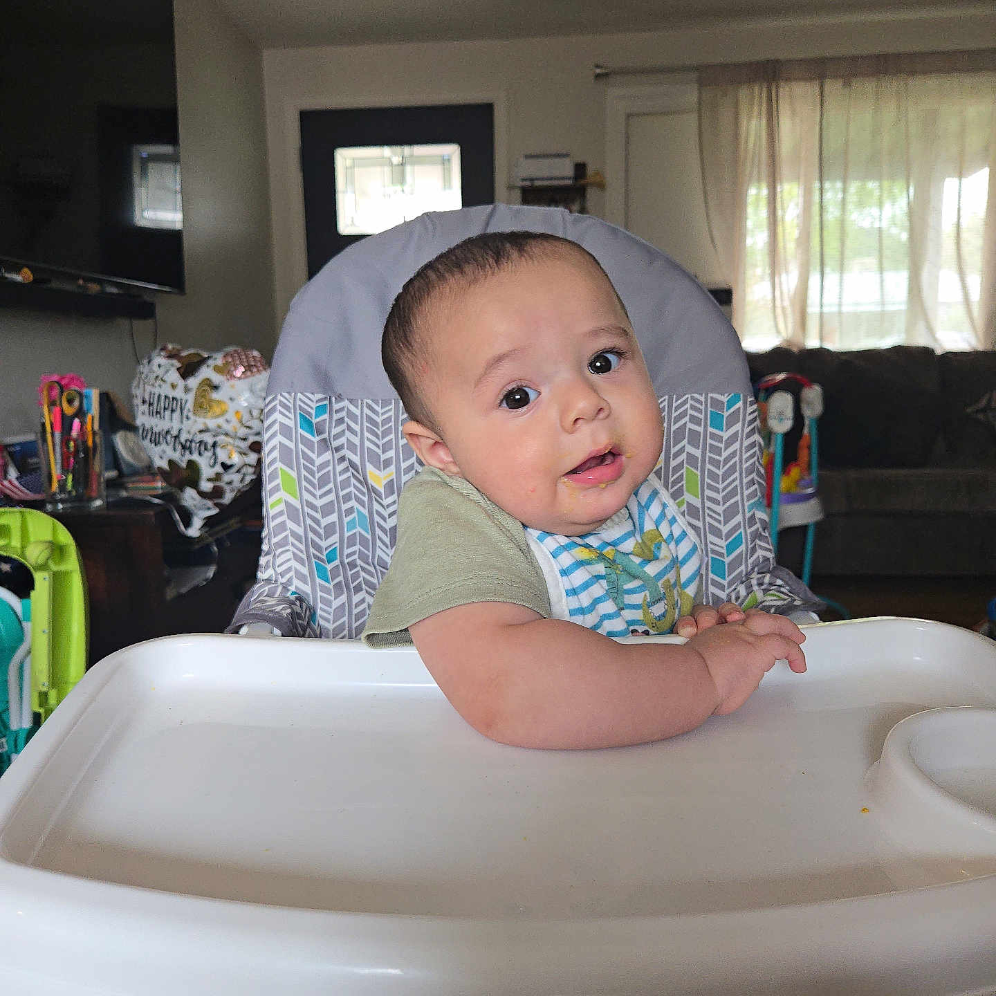 Carlos A Murillo joined the competition — help win amazing prizes! baby, bib, child, curious, cute, expression, face, feeding, food, furniture, high_chair, home, indoor, infant, living_room, person, portrait, seat, table, young