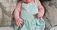 Trinity joined the competition — help win amazing prizes! baby, child, infant, dress, mint_green, pillow, couch, indoor, cute, face, portrait, sitting, skin, arm, leg, expression, person, young, head, comfortable
