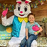 Kenji is registered to the contest to win money with this photo: child, boy, person, mascot, easter_bunny, costume, bench, cushion, decorations, wood, smile, happy, rain_boots, spiderman, blue_jeans, tshirt, pink_gloves, yellow_bow, face, outdoor