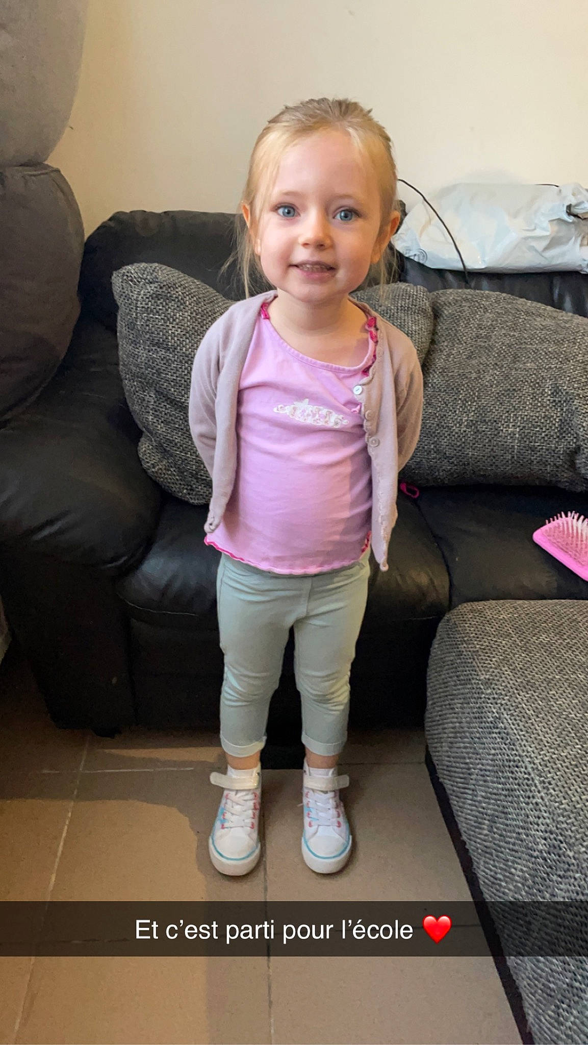 Innayah participe au concours pour gagner de l'argent avec cette photo : baby_toddler_clothing, cheek, child, comfort, couch, eye, face, flooring, human_leg, joy, living_room, magenta, person, pink, room, sitting, sleeve, smile, sock, thigh