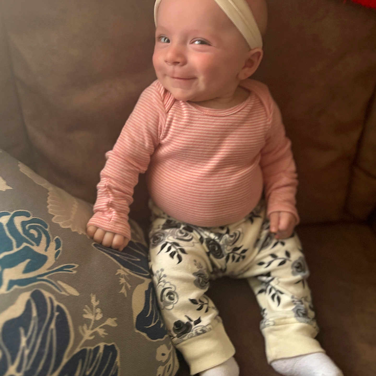 Justine is registered to the contest to win money with this photo: baby, bodypart, clothing, couch, cushion, face, finger, furniture, hand, happy, head, homedecor, hosiery, pants, person, photography, portrait, sitting, smile, sock