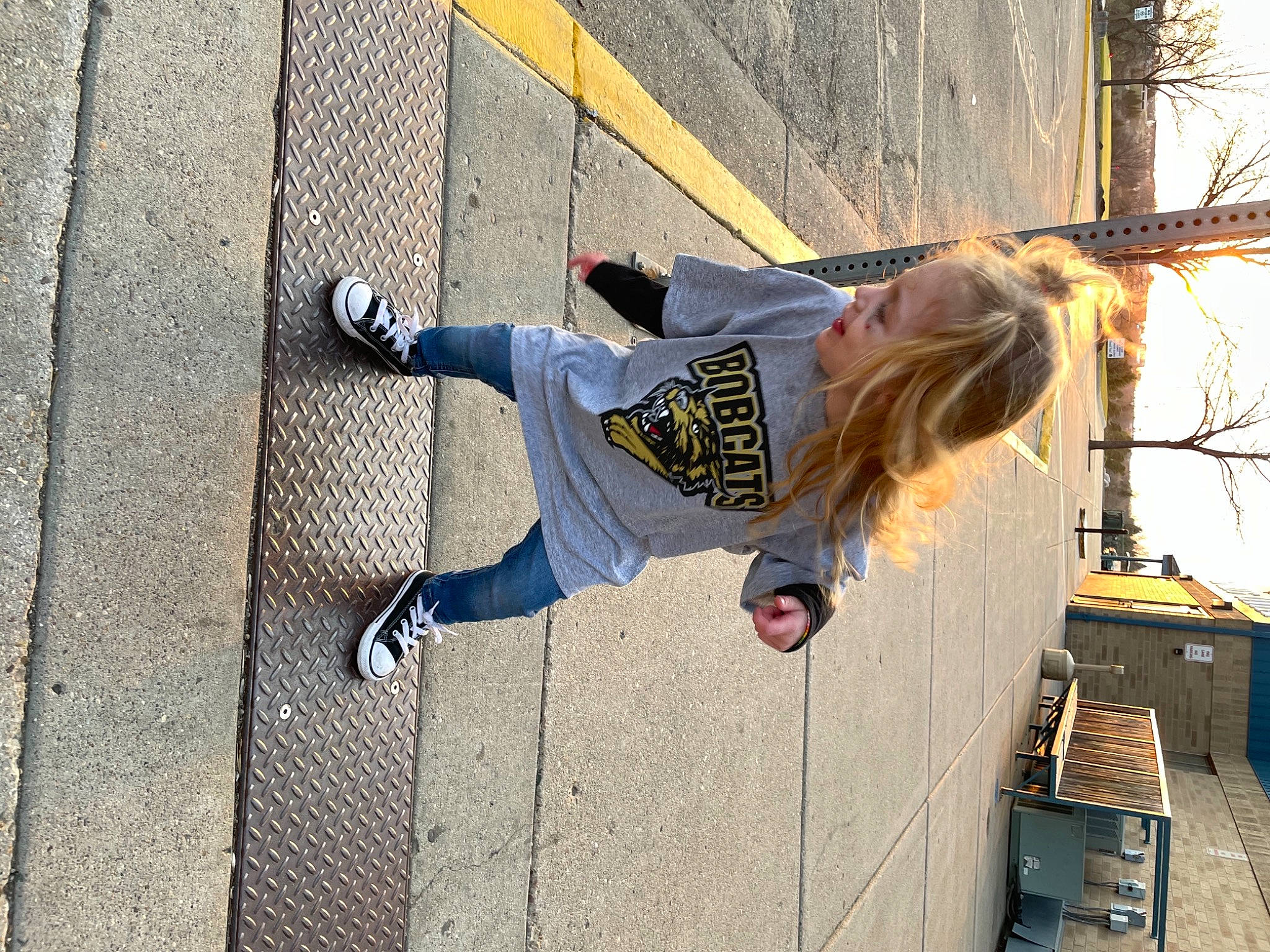 Asher is registered to the contest to win money with this photo: clothing, composite_material, concrete, denim, electric_blue, fun, human_leg, leisure, outdoor_shoe, pedestrian, person, recreation, road_surface, shadow, sidewalk, street_fashion, t_shirt, thigh, waist, walking_shoe