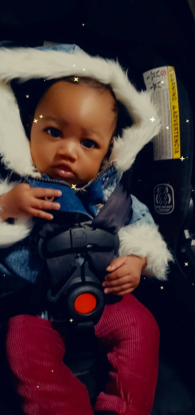 Na'Lani is registered to the contest to win money with this photo: arm, baby, baby_carriage, baby_products, baby_safety, baby_toddler_clothing, cheek, child, comfort, cool, electric_blue, finger, hand, happy, nose, person, product, skin, sleeve, thumb