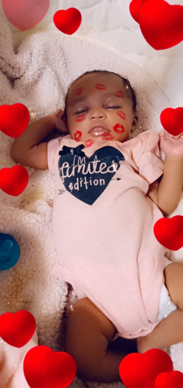 Na'Lani is registered to the contest to win money with this photo: arm, baby, baby_toddler_clothing, cheek, eye, face, facial_expression, finger, hand, happy, head, headwear, human_body, leg, lip, nail, person, pink, red, skin