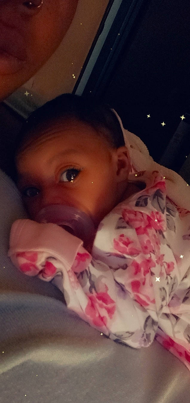 Na'Lani is registered to the contest to win money with this photo: baby, carmine, cheek, child, comfort, event, eyebrow, eyelash, finger, flesh, hand, human_body, lip, mouth, nail, nose, person, pink, skin, thumb