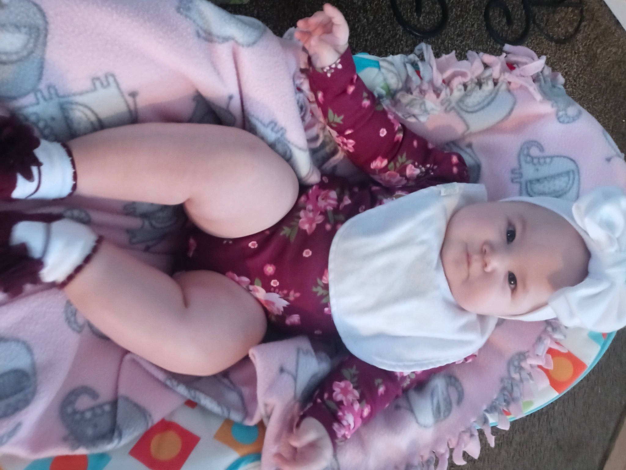 Ciara is registered to the contest to win money with this photo: baby, baby_toddler_clothing, cheek, child, comfort, eye, headgear, human_body, human_leg, lap, mouth, pattern, people, person, pink, purple, skin, thigh, toddler, trunk