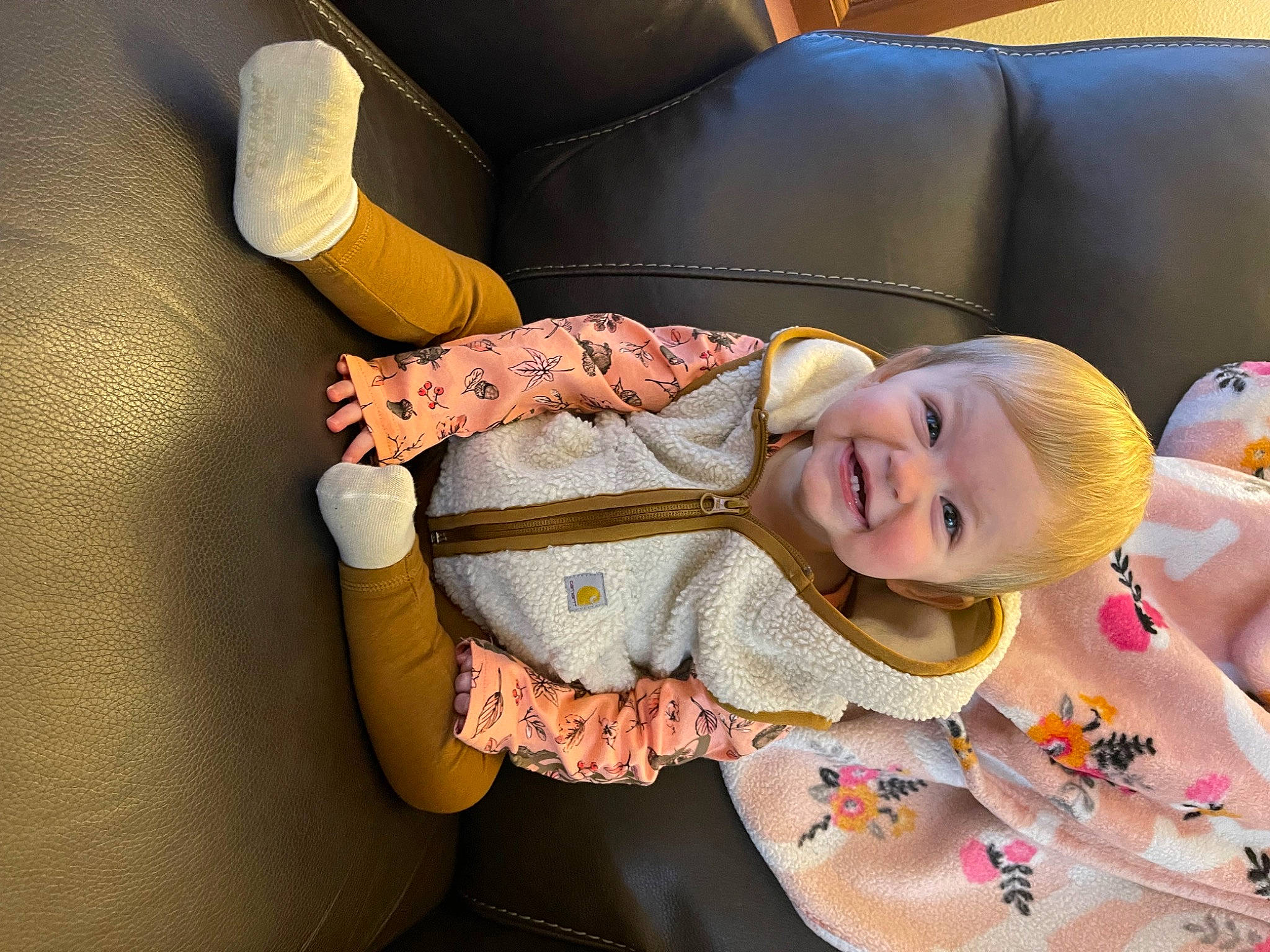 Charlee joined the competition — help win amazing prizes! baby, baby_products, baby_toddler_clothing, car_seat, cheek, child, comfort, couch, happy, human_leg, joy, lap, linens, orange, pattern, person, room, sitting, smile, textile