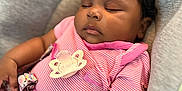 Raelynn joined the competition — help win amazing prizes! baby, sleeping, infant, pacifier, pink_clothing, striped_shirt, cushion, seat, child, peaceful, indoors, cute, resting, portrait, young_child, soft_lighting, person, relaxing, baby_girl, comfortable