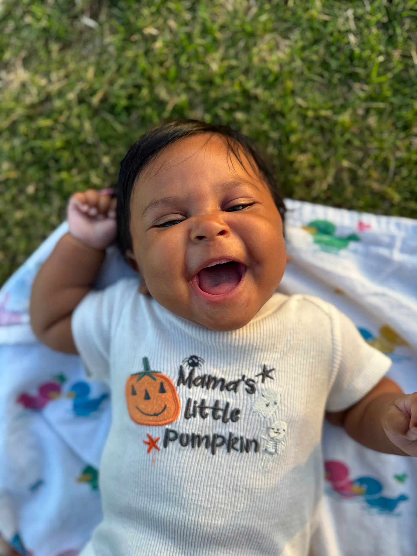 Raelynn is registered to the contest to win money with this photo: baby, smiling, happy, infant, grass, blanket, cute, shirt, pumpkin, outdoor, child, person, portrait, clothing, joyful, laughter, babywear, toddler, fun, nature