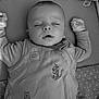 Arlo is registered to the contest to win money with this photo: baby, sleeping, onesie, plush_toys, blanket, infant, soft_toys, cozy, black_and_white, peaceful, child, cute, indoors, resting, clothing, person, toddler, bedtime, calm, portrait