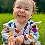 baby, child, smiling, happy, grass, outdoor, colorful_clothing, heart_pattern, cute, portrait, nature, young_child, sitting, sunlight, hands, face, joyful, casual_wear, daylight, infant