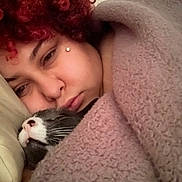 Gojira joined the competition — help win amazing prizes! person, cat, blanket, curly_hair, red_hair, sleeping_cat, cozy, close_up, indoor, soft_lighting, resting, face, fur, whiskers, pillow, relaxing, intimate, warm, nap, comfort