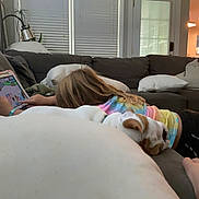 Louie Potato joined the competition — help win amazing prizes! child, tablet, dog, bulldog, couch, pillows, living_room, indoor, casual, playing, relaxing, tie_dye_shirt, blonde_hair, furniture, technology, home, cozy, pet, sleeping, family