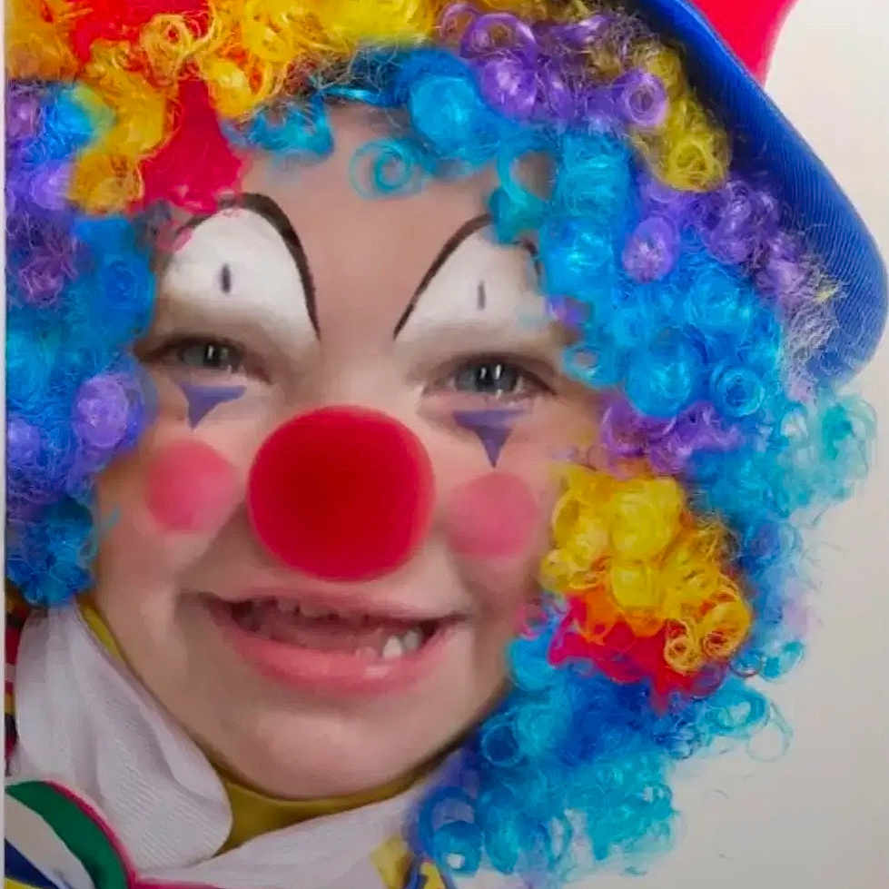 Aurora joined the competition — help win amazing prizes! child, clown, face_paint, red_nose, curly_hair, wig, rainbow_colors, bow_tie, smile, costume, party, colorful, portrait, fun, happy, hat, plaid, makeup, closeup, person