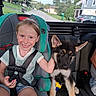 Shae is registered to the contest to win money with this photo: child, girl, puppy, dog, german_shepherd, smiling, portrait, car, car_seat, seatbelt, indoors, vehicle, road, neighborhood, residential, outdoor, trees, grass, house, daylight