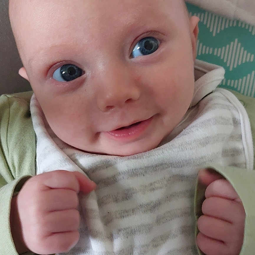 Arthur is registered to the contest to win money with this photo: baby, bed, bodypart, clothing, cushion, face, finger, fist, furniture, hand, happy, head, homedecor, newborn, pants, person, photography, portrait, quilt, smile