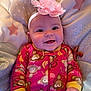 baby, child, closeup, cushion, cute, face, flower, hand, happy, headband, indoor, infant, monkey_print, onesie, pink, portrait, sleepwear, smiling, soft, star_pattern