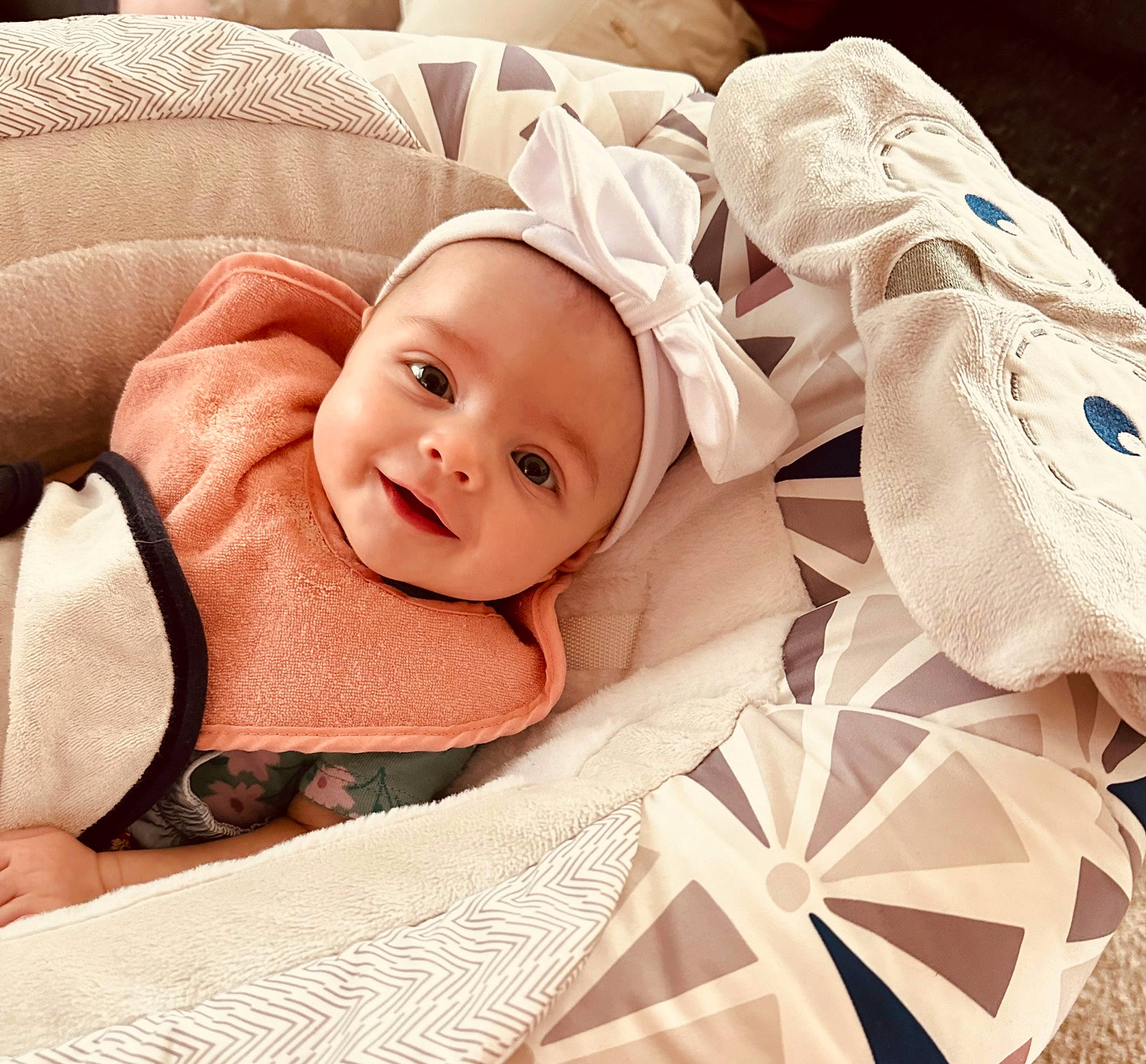 Remington is registered to the contest to win money with this photo: baby, baby_products, baby_sleeping, baby_toddler_clothing, child, collar, comfort, event, facial_expression, fashion_accessory, happy, headgear, headwear, linens, pattern, person, portrait_photography, sleep, sleeve, smile