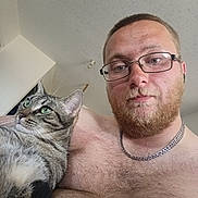 Nuna participe au concours pour gagner de l'argent avec cette photo : man, beard, glasses, shirtless, cat, tabby_cat, indoor, portrait, closeup, pet, feline, green_eyes, chain_necklace, hairy_chest, calm, looking_away, human, animal, companion, casual