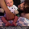 baby, infant, adult, person, bed, blanket, pillow, pajamas, stars, holding, lying_down, indoor, parent, child, face, hand, love, family, cuddling, sleepwear