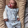 Célina-Marie a rejoint le concours — aidez-le/la à gagner de superbes lots ! baby, pacifier, striped_dress, blue_and_white, buttons, infant, cushion, beige, sleepy, clothing, newborn, cute, small_hands, tiny_feet, indoors, portrait, resting, child, peaceful, soft_fabric