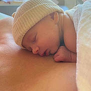 Célina-Marie participe au concours pour gagner de l'argent avec cette photo : baby, newborn, sleeping, hat, blanket, skin, face, hand, closeup, soft, cozy, rest, peaceful, indoor, portrait, infant, comfort, warmth, person, relaxation