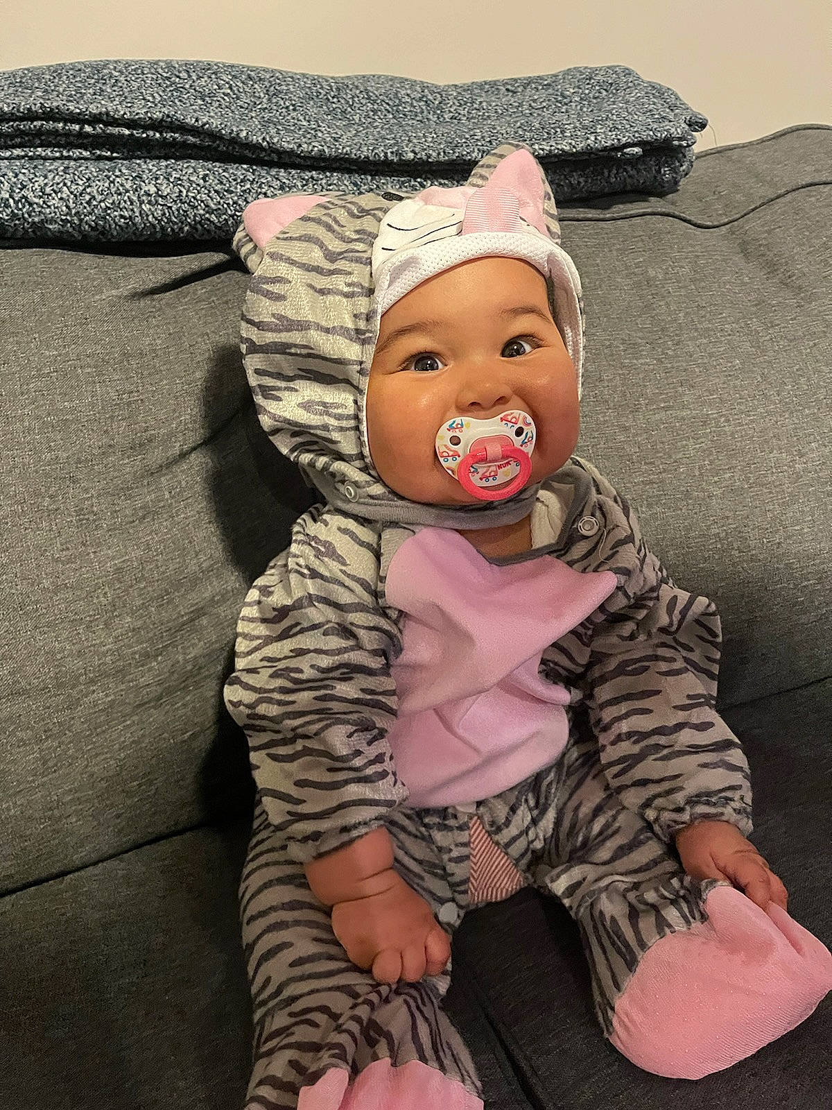 Gabriella is registered to the contest to win money with this photo: baby, baby_sleeping, baby_toddler_clothing, bedding, cap, child, comfort, costume_hat, fashion_accessory, finger, happy, hat, headwear, linens, pattern, person, pink, sitting, sleeve, textile