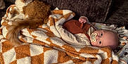 Freya joined the competition — help win amazing prizes! baby, cat, blanket, couch, fur, pacifier, infant, orange_cat, plush, wood_floor, indoor, cute, relaxed, sleepwear, patterned_blanket, comfort, pet, child, resting, warm