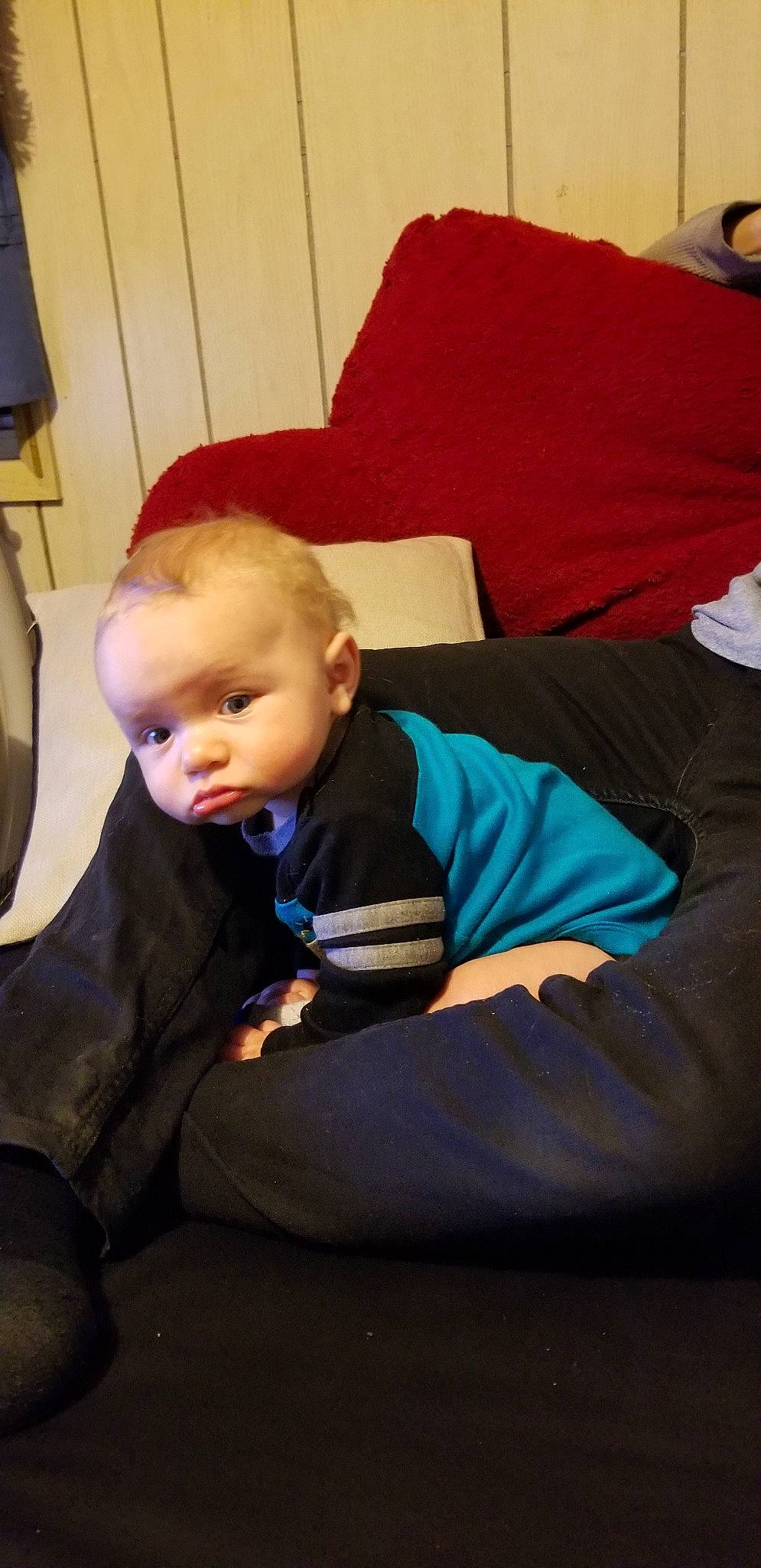 Sebastian is registered to the contest to win money with this photo: arm, baby, child, comfort, couch, furniture, leg, person, sitting, toddler