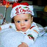 Kayden joined the competition — help win amazing prizes! baby, child, blue_eyes, christmas_hat, holiday, pajamas, blanket, indoor, face, portrait, cute, infant, festive, smiling, cozy, young_child, expression, person, soft_texture, holiday_season
